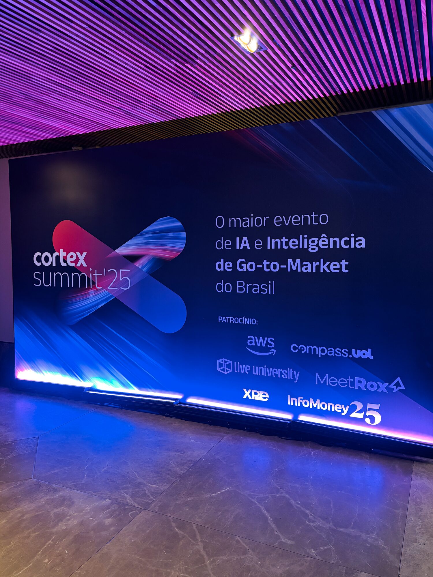Backdrop do ponto de fotos do Cortex Summit 2025 com identificação dos patrocinadores